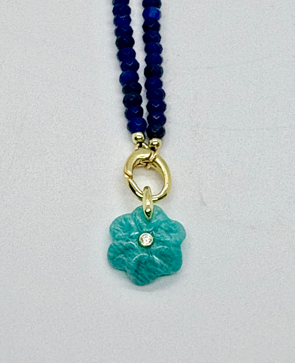 Navy beaded necklace with green flower