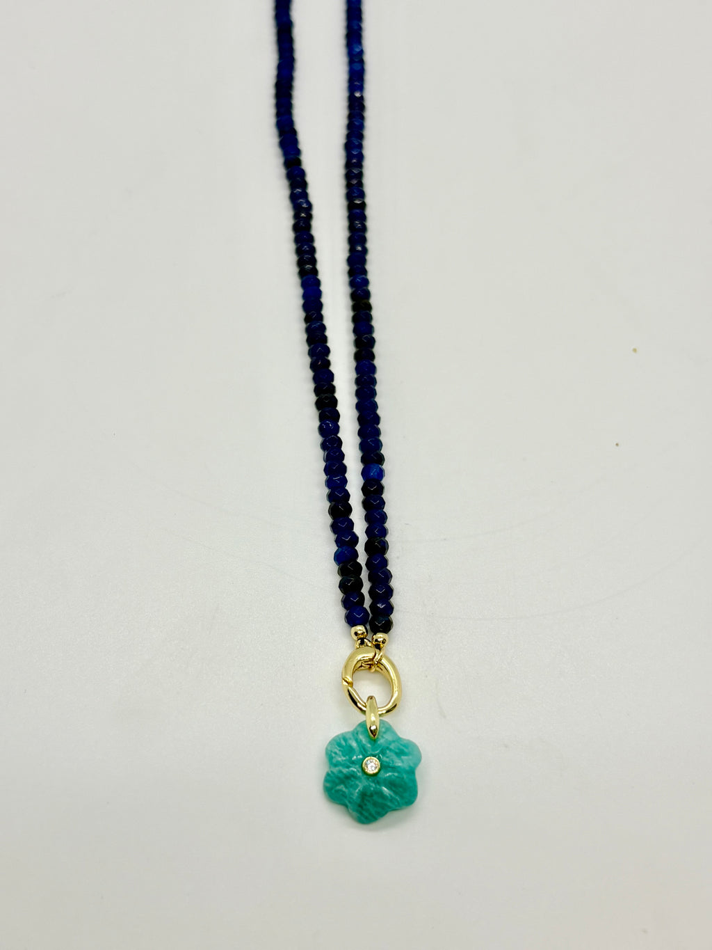 Navy beaded necklace with green flower